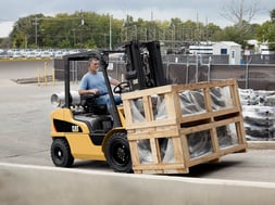 Man on forklift lifting boxes