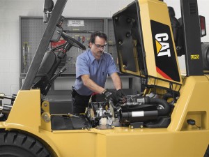 Forklift operator conducting a Pre-Operational inspection before a shift.