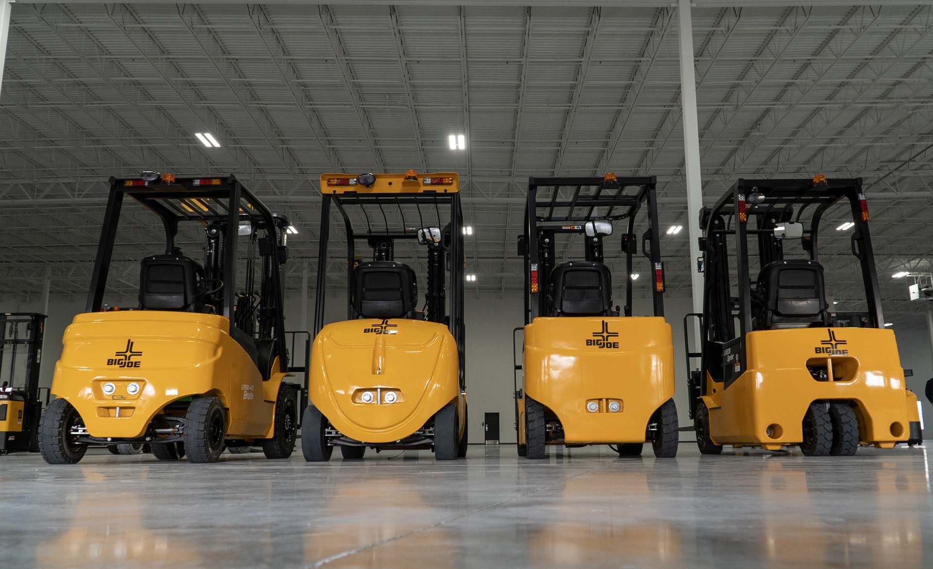 A row of Big Joe forklifts in a warehouse