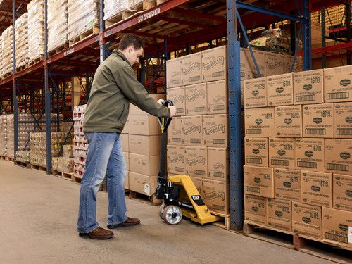 Man using CAT pallet jack in warehouse