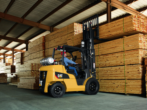 Man utilizing 8,000 – 12,000 lb. forklift in warehouse