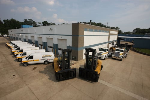 Partial aerial view of Fallsway Equipment Company’s service vans, forklifts and truck display